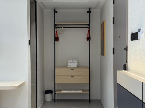a bathroom with a walk in closet with a mirror at Goldlight Inn in Miri