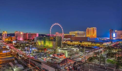 a view of a city at night with a roller coaster at The Platinum Hotel Las Vegas in Las Vegas