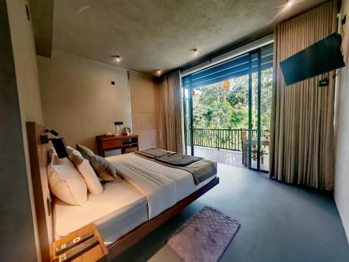 a bedroom with a bed and a large window at Liora Lodge Ella in Ella