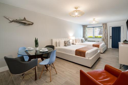 a hotel room with a bed and a table and a dining room at Waterside Hotel and Suites in Miami Beach