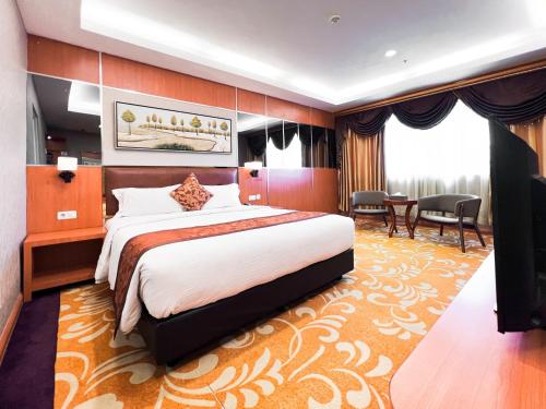 Postel nebo postele na pokoji v ubytování Batam City Hotel