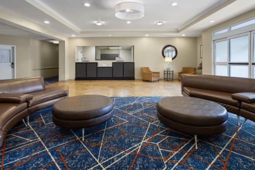 a lobby with couches and chairs and a living room at Candlewood Suites Norfolk Airport by IHG in Norfolk
