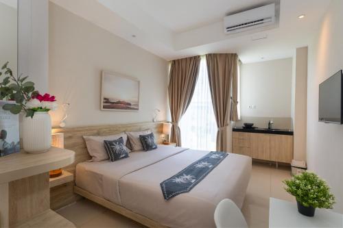 a bedroom with a large bed in a room at Bali Bustle Pararaton Coliving and Coworking Space in Legian