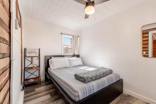 a bedroom with a bed with a ceiling fan at Brews, Bites, & Pines - Your downtown Flagstaff suite in Flagstaff
