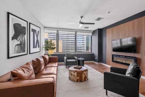a living room with a couch and a tv at Luxury 17th Floor Downtown Dallas High-Rise with Free Parking, City Views, Pool & Gym in Dallas