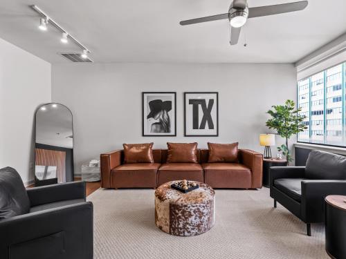 a living room with a couch and a table at Luxury 17th Floor Downtown Dallas High-Rise with Free Parking, City Views, Pool & Gym in Dallas