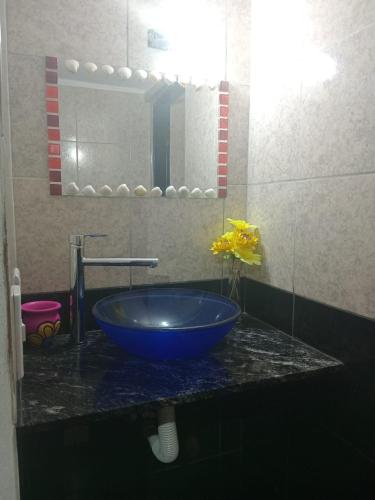 a bathroom sink with a blue bowl on a counter at Casa Camila in Villa Cura Brochero