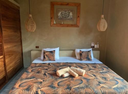 a bedroom with a large bed with pillows on it at Casa Maloya alberca y vista al mar in Puerto Escondido