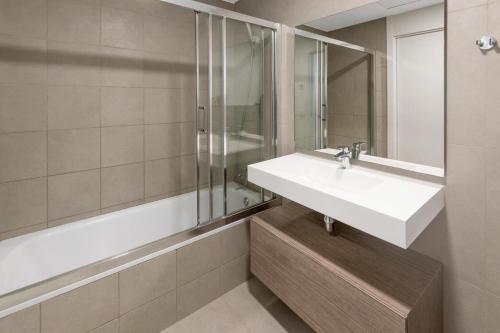 a bathroom with a sink and a shower at Waterfront Seaview Residence in Villajoyosa