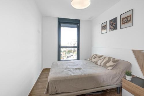 a bedroom with a bed and a window at Waterfront Seaview Residence in Villajoyosa