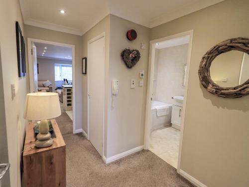 a bathroom with a toilet and a mirror on the wall at Lakeland Loft in Windermere