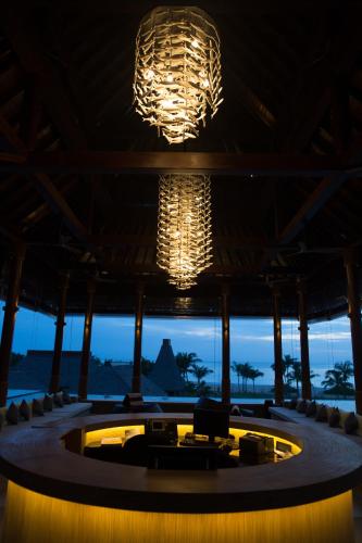 a large lobby with chandeliers and a pool at Anantaya Resort and Spa Passikudah in Pasikuda