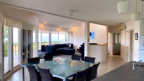 a dining room and living room with a table and chairs at Pelicans Perch - Scenic Coastal Retreat in Lake Tyers