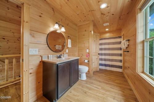a log cabin bathroom with a sink and a toilet at Cabin in Sevierville in Sevierville