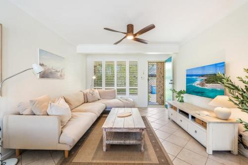 a living room with a couch and a ceiling fan at Sea Haven in Lennox Head