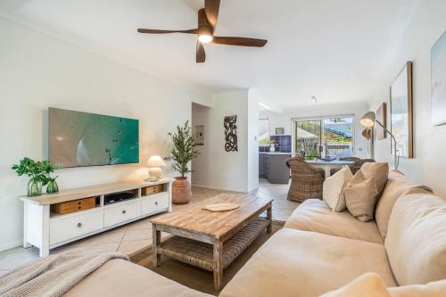 a living room with a couch and a tv at Sea Haven in Lennox Head