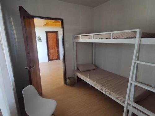 a room with two bunk beds and a mirror at Bogartz Homestay in Mati