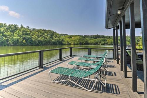 four green lounge chairs on a dock next to the water at Dockside Lakefront Escape Deck Views in Jacksons Gap