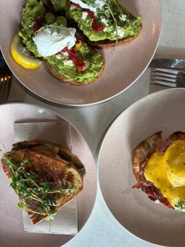 two plates of food with sandwiches and a salad at Roamer St Kilda in Melbourne