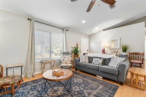 a living room with a couch and a table at Life's a Breeze - 5min to Pcola Beach , Families in Gulf Breeze