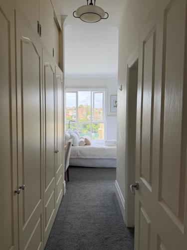 a hallway with a room with a bed and a window at Neutral Bay Stunning Two Bedroom Apartment in Sydney