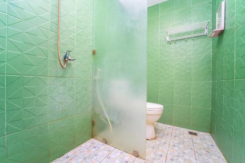 a bathroom with a shower with a toilet in it at Hotel Tiara By ARBA in Weleri