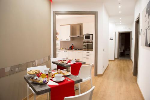 a kitchen and dining room with a table and chairs at B&B Homedesign in Salerno
