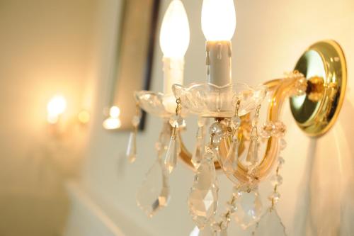 a chandelier is hanging in front of a mirror at Millenium Palace in Ohrid