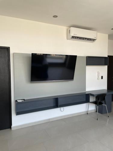 a flat screen tv hanging on a wall at Loftstay MYO in Monterrey