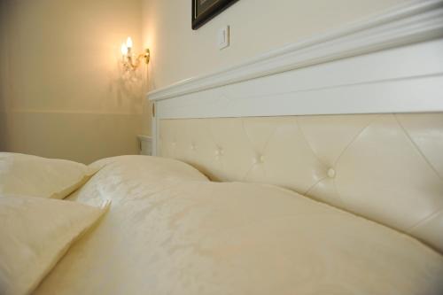 a bedroom with two beds with white sheets at Millenium Palace in Ohrid