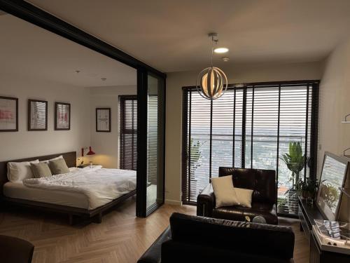 a bedroom with a bed and a couch and a chair at CARTER Flat in Ho Chi Minh City