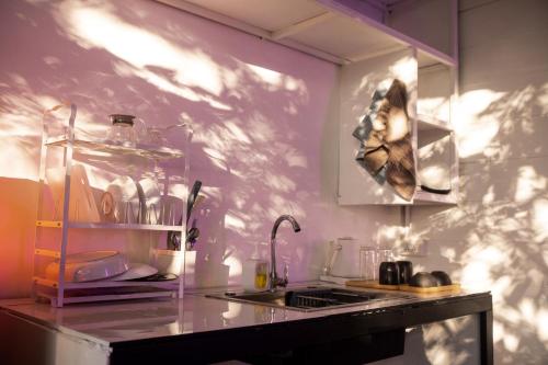 a kitchen with a sink and a counter top with a sink at MESTO Koh Phangan - Creative Stay & Community Hub in Thong Sala