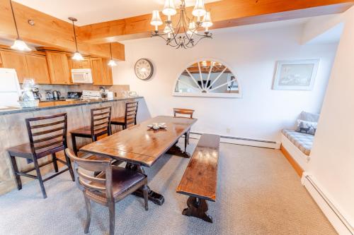 a kitchen and dining room with a wooden table and chairs at Snowmass 2br Getaway Pool, Hot Tub & Ski Access - D2 in Snowmass Village