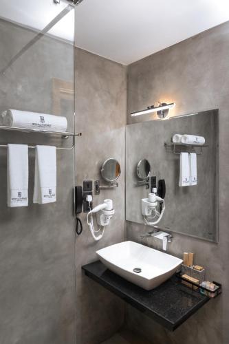 a bathroom with a sink and a glass shower at Royal Avenue Kandy in Kandy