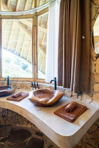 a stone bathroom with a wooden sink on a counter at Villa Cecilia Luxury with Sea view Pool - ANIMA Eco Lodge in Selong Belanak