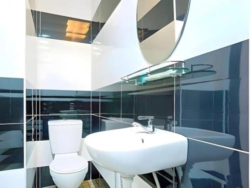 a bathroom with a white sink and a toilet at HP Hope Hotel in Johor Bahru