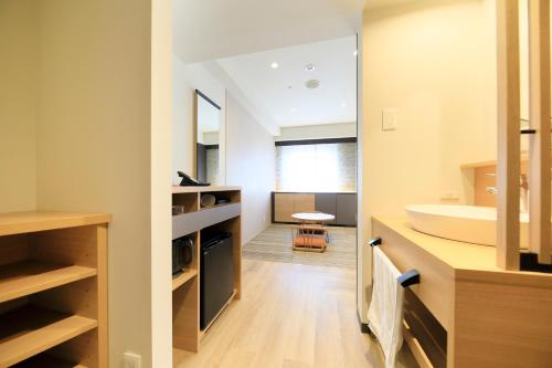 a bathroom with a sink and a mirror at Richmond Hotel Matsumoto in Matsumoto