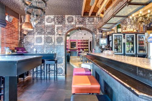 a bar with colorful stools in a restaurant at RAVeL Hotel Cyrano in Waimes