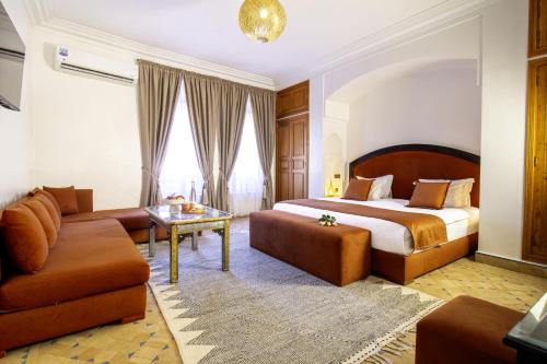 a hotel room with a bed and a couch at Riad Zaki Marrakech in Marrakesh