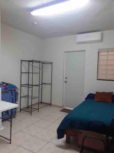 a bedroom with a bed and a white wall at Loft 1 with 2 beds near Fundidora and Cintermex in Monterrey