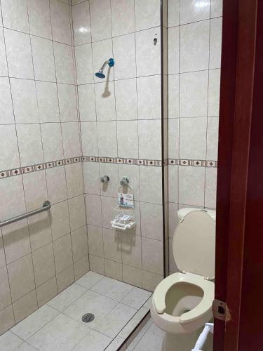 a bathroom with a shower and a toilet at Loft 1 with 2 beds near Fundidora and Cintermex in Monterrey