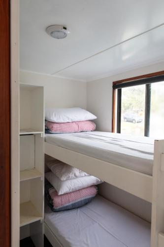 a bedroom with two bunk beds and a window at Waterscape Floating Apartment in Augusta