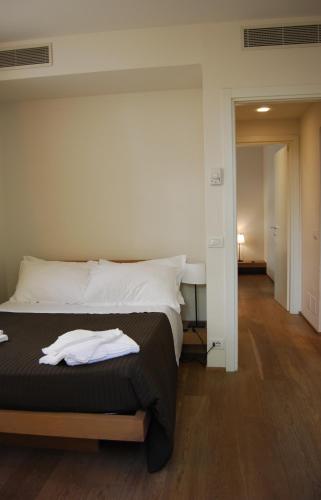 a bedroom with a bed and a hallway at Ceccarini Suite in Riccione