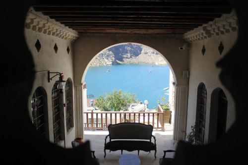 an archway in a building with a view of the water at Kasr-ı Canan in Halfeti