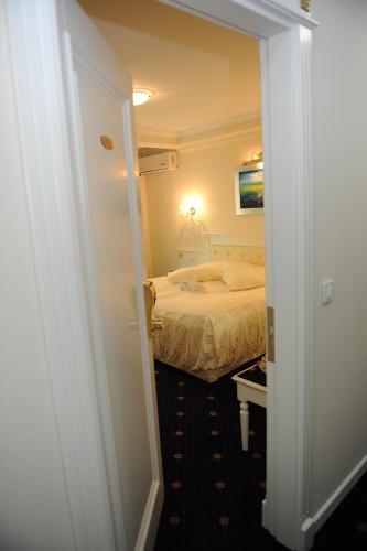 a bedroom with a bed and a door leading into a room at Millenium Palace in Ohrid