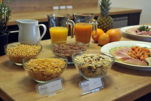 a table topped with bowls of food and drinks at Bold´S Hotel-Restaurant "Zum Grünen Kranz" in Rodalben