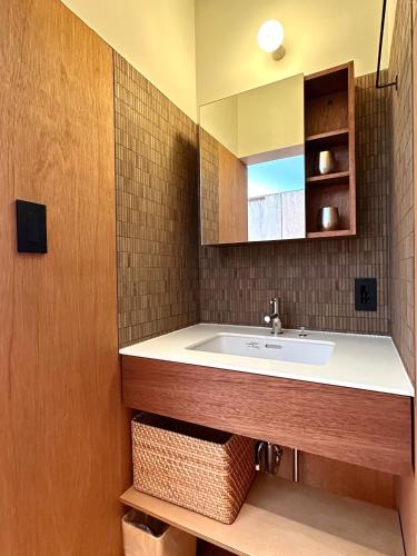 a bathroom with a sink and a mirror at Otsu Guesthouse Seiseki - Vacation STAY 90442v in Otsu