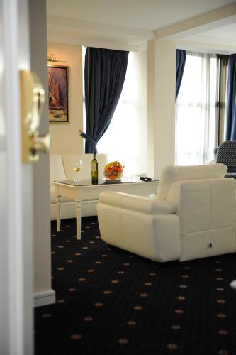 a living room with a white couch and a table at Millenium Palace in Ohrid