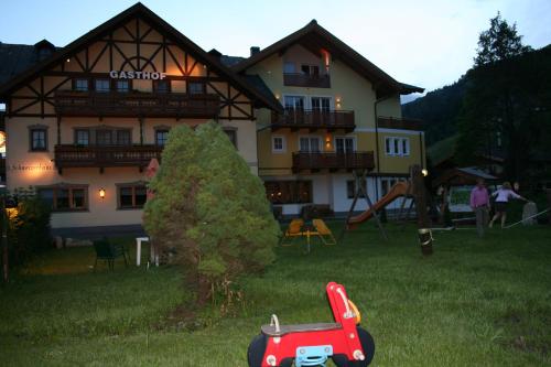 a house with a toy car in front of it at Hotel Gasthof Schweizerhaus in Stuhlfelden