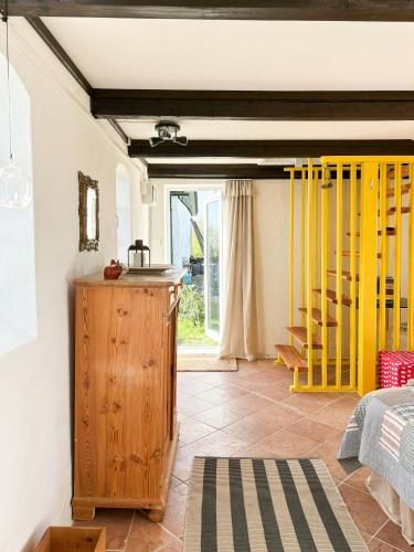 a room with a bed and a yellow railing at Rural Guest House Between Simrishamn And Skillinge in Simrishamn